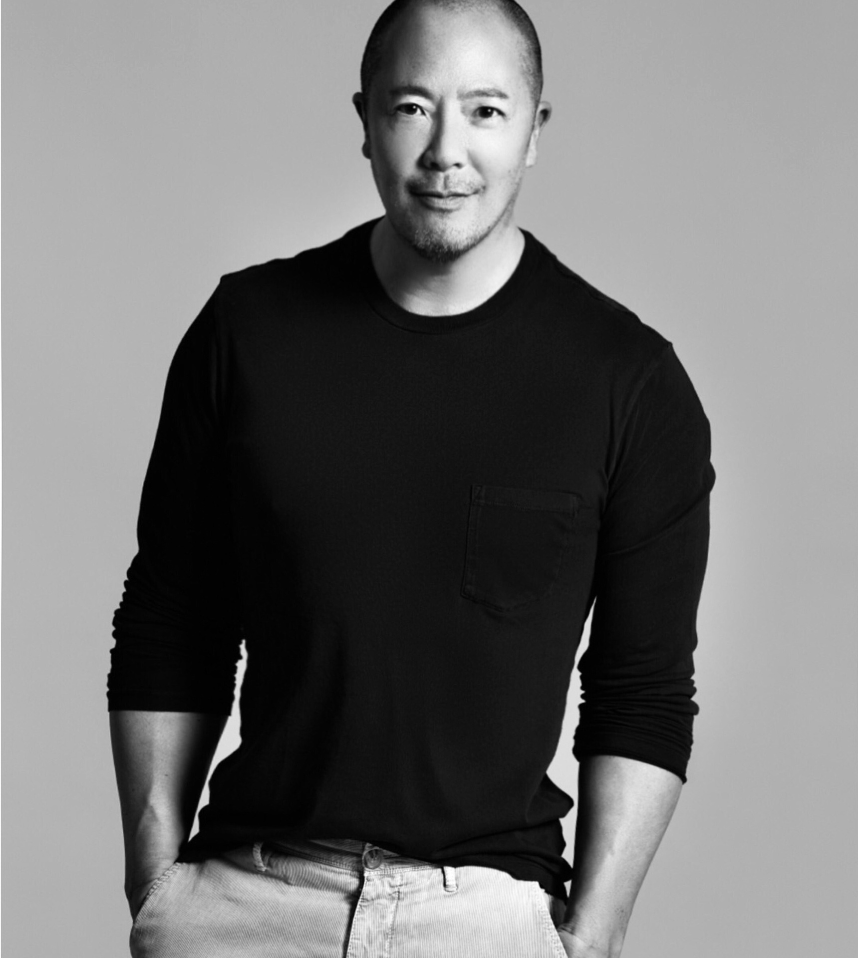 Derek Lam leaning against a wall Derek Lam leaning against a wall