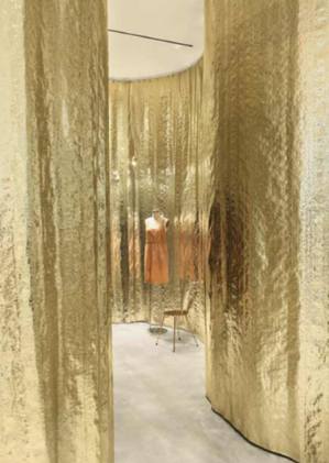 Detail of a store section with golden walls and a mannequin inside Detail of a store section with golden walls and a mannequin inside